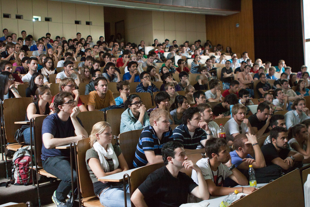 College students sitting in a lecture hall.