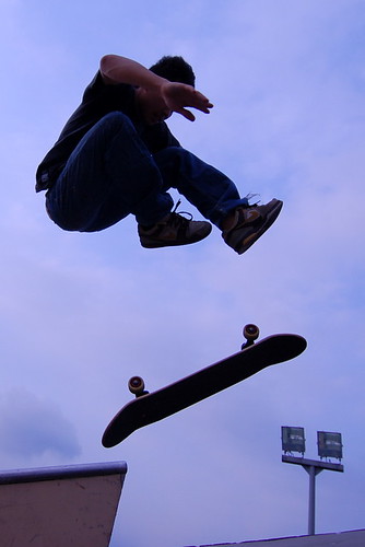Silhouette of a male doing a skateboard trick.