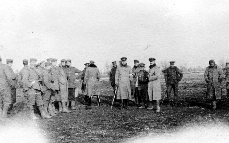 Black and white image of WWI soldiers standing in a field.