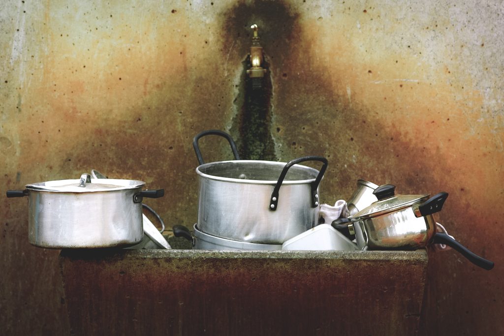 Silver pans in a primitive sink.