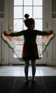 Girl with butterfly wings imagining something
