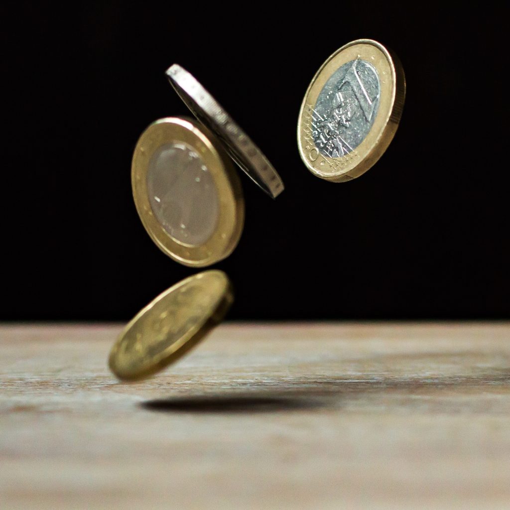 Euro coins falling onto a table