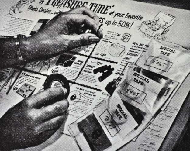 layout of newspaper page with human hands using black tape to manually input framing lines between elements