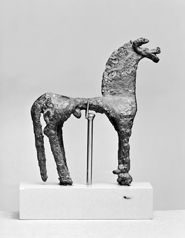 Stone horse-figure suspended on a staff under its stomach