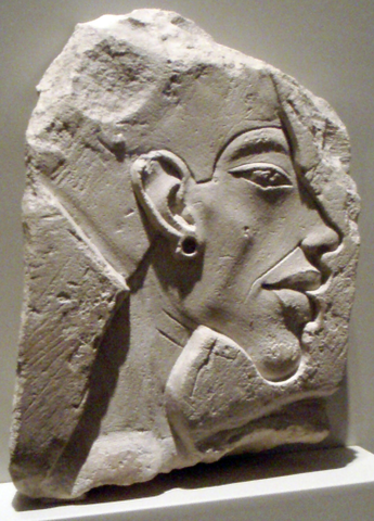 Carving in stone of the side of a man's face with an earring