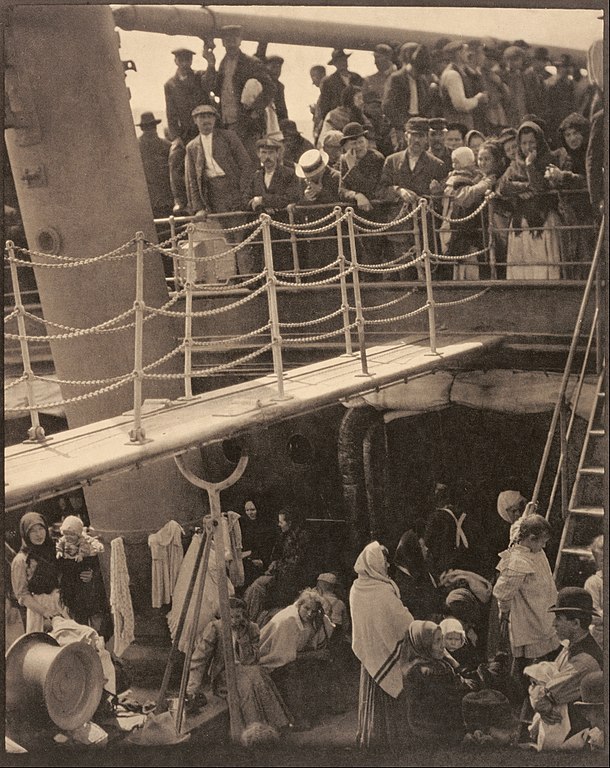 Crowds of people on top and bottom levels of a ship