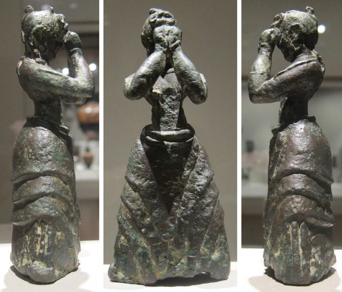 Two side views and a front view of a stone woman covering her face
