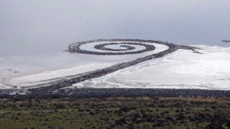 Spiraling jetty of rock extending into the ocean
