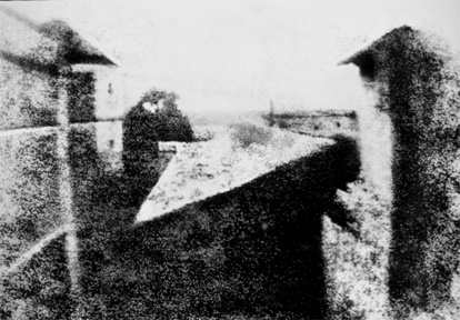 Blurry view of a person in a stone path beside a stone table
