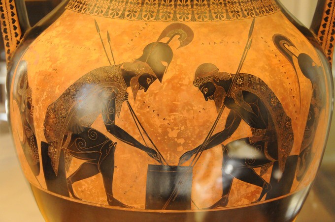 Light gold vase with dark men bending over a board game while holding spears