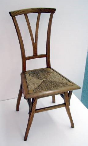 Small wooden chair with woven seat