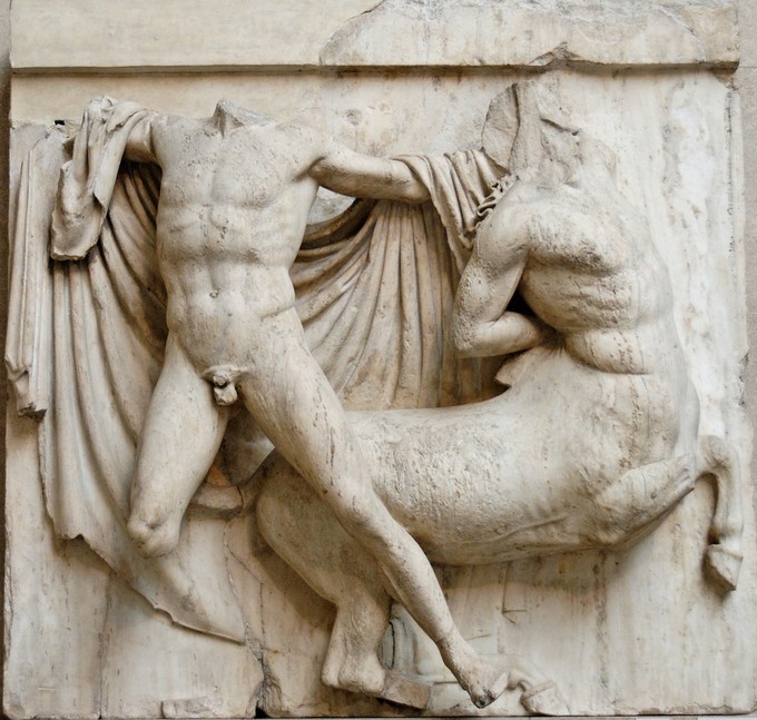 Headless naked man and headless centaur in front of a cloak on a wall