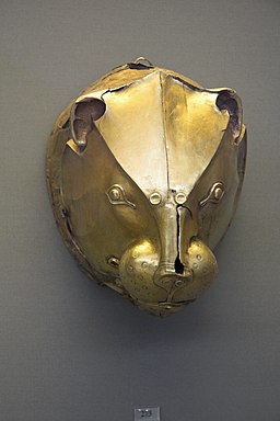 Golden head of a lion with armor on head
