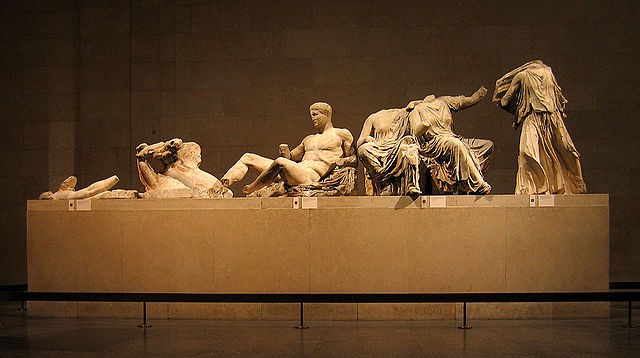 Group of sculpted people reclining on a platform