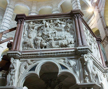 Stone caring of a group of people on the side of an indoor balcony