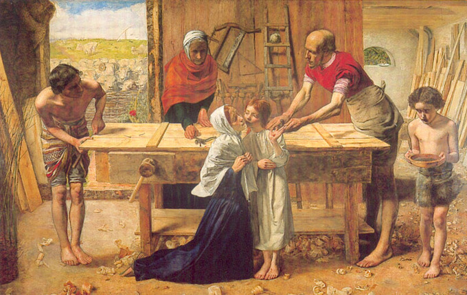 Woman kneeling beside a little boy while another boy brings a bowl towards three men carving a door