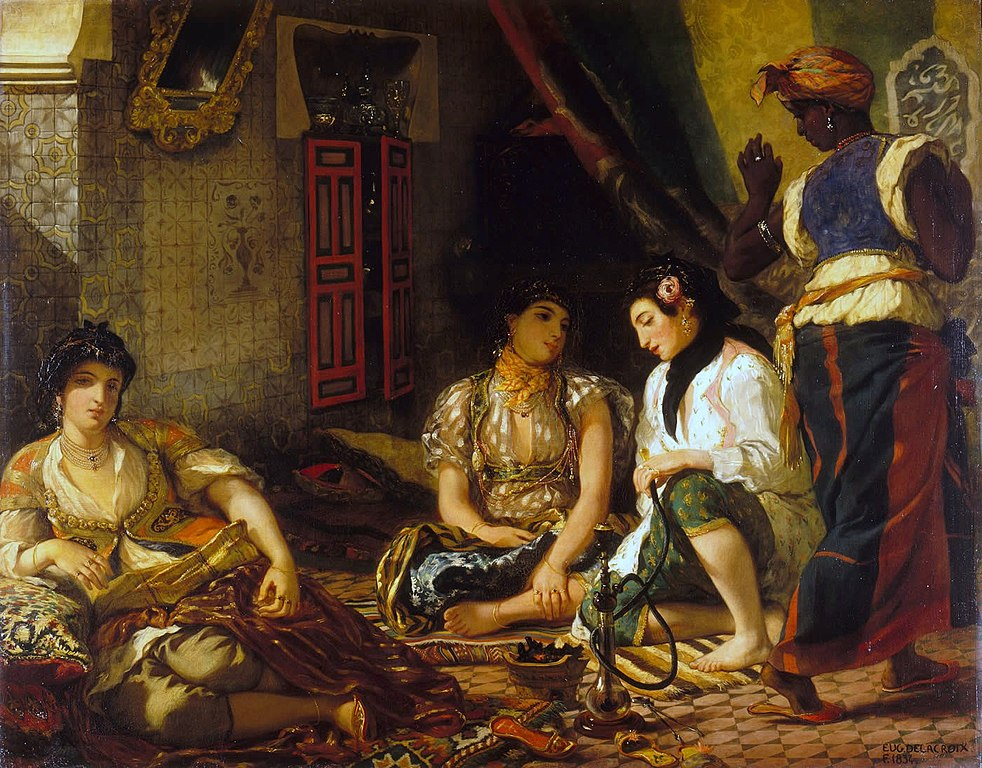 A group of dark haired women seated in a harem