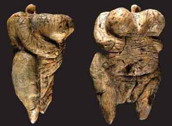 Two stone figures resembling fat women with large breasts and small heads