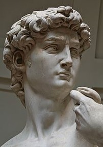 Head of a man looking to the side with curly hair and stern eyes