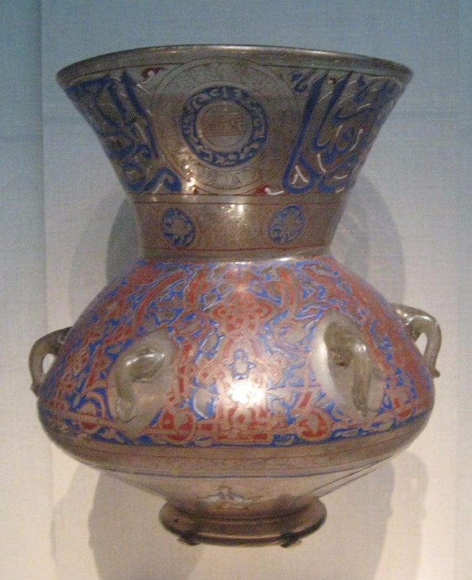 Round vase with a cone-like top decorated with red and blue flower designs