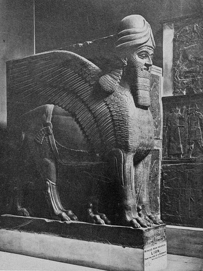 Giant stone lion figure with wings and a human head with beard