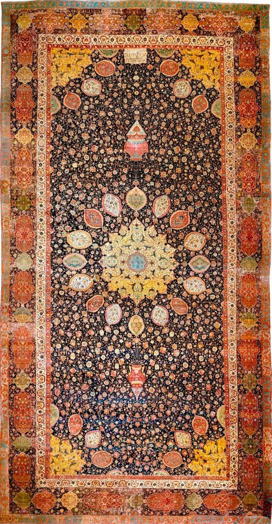 Long carpet with red and green edges and many colored shapes in the center