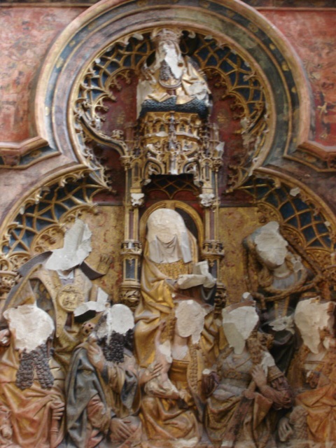 Decorated arch over a crowd of people with their faces cut off