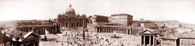 Large round courtyard surrounded by pillared buildings in front of a dome