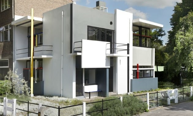 Square white building with several balconies and outcroppings