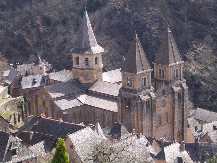 Large church with tall steeples against a mountain