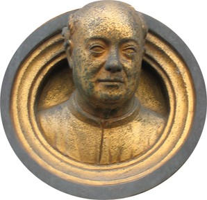 Golden head of a bald man sticking his head out from a round window