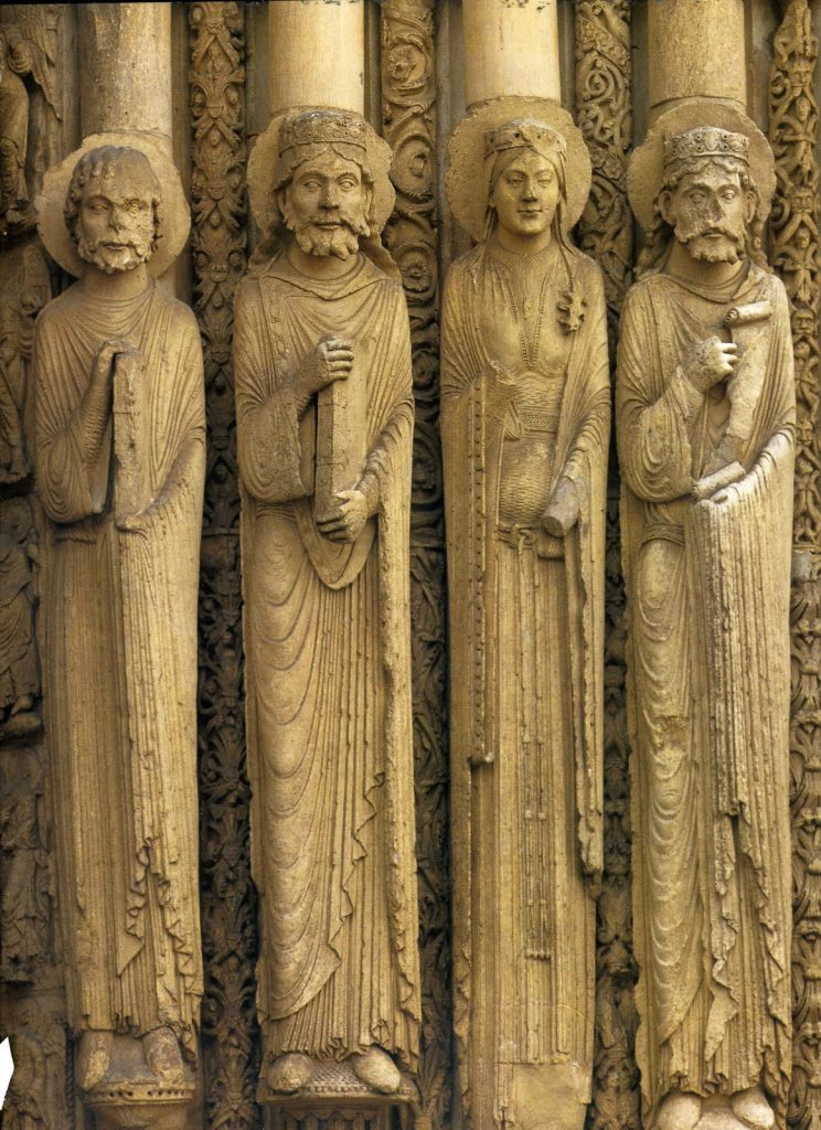 Four stone figures in long robes suspended on pillars