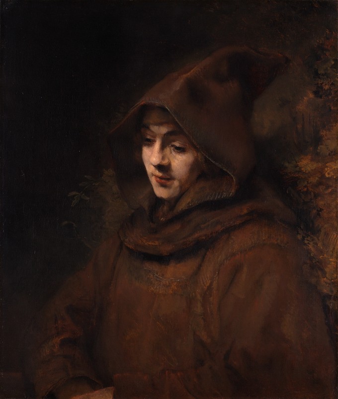 A man in a robe and hood in a dark background