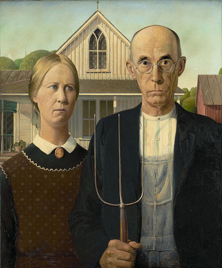 A tall farmer with a pitchfork standing with his wife in front of a farmhouse