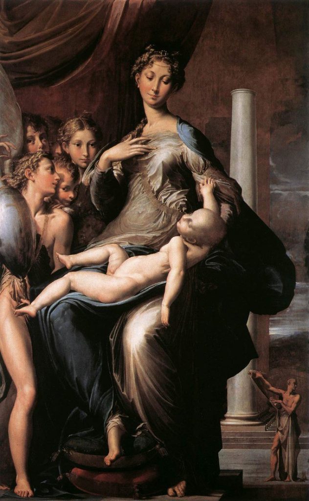 Woman holding a large bald baby while young girls look on
