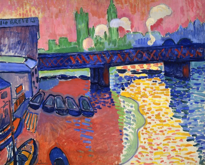 Brightly colored lake under a bridge beside a city with boats on the shore