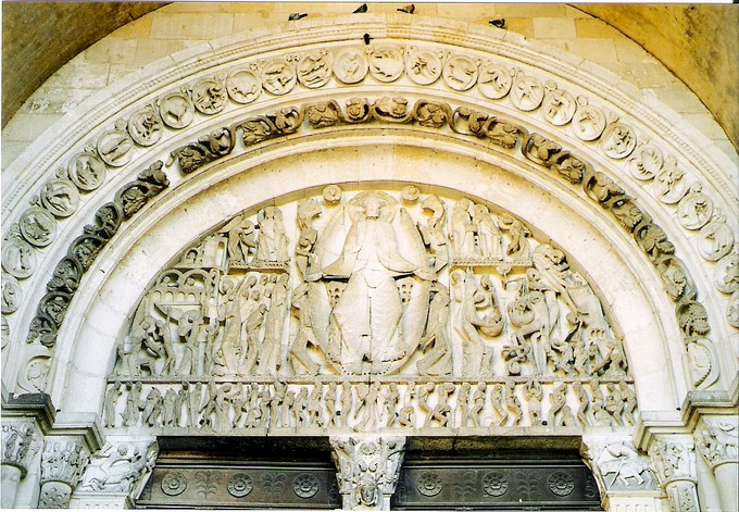 Carvings of human figures on an arch above doors