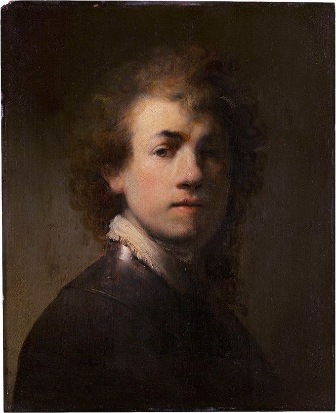 A young man with curly hair looking worried