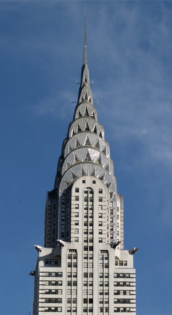 Tall spire on a building full of windows