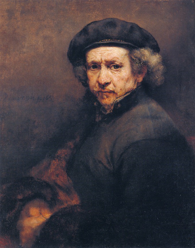 An old man with a hat on curly hair looking sternly out