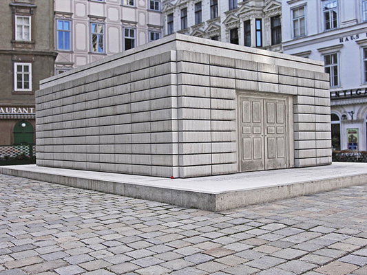 Rectangular stone building on brick ground