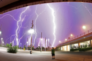 Several streaks of lightning hitting a city