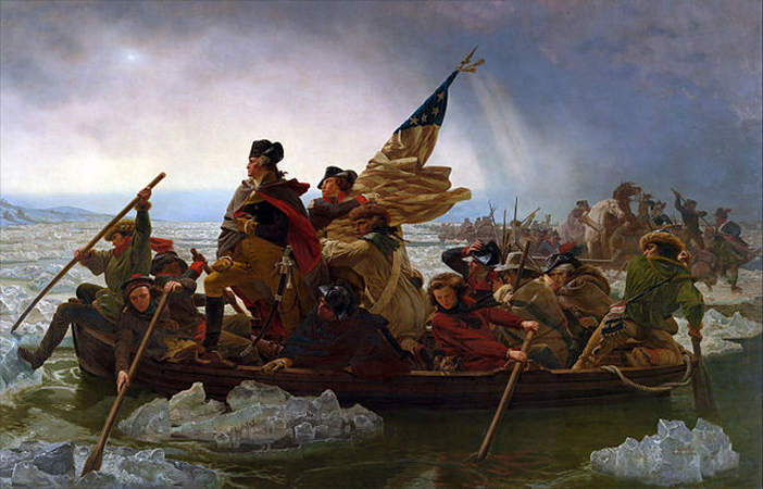 Group of men in a boat holding an American flag and steering through glaciers