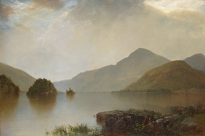 Still lake with islands in front of mountains and a cloudy sky