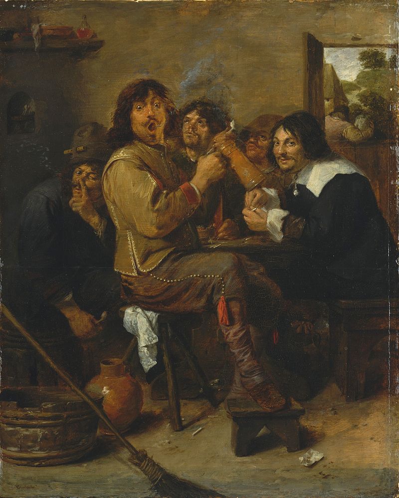 Several drunk men gathered around a table in a dark room