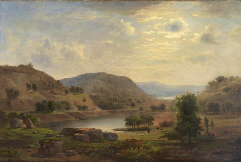 Valley with a small lake beside bush-covered hills