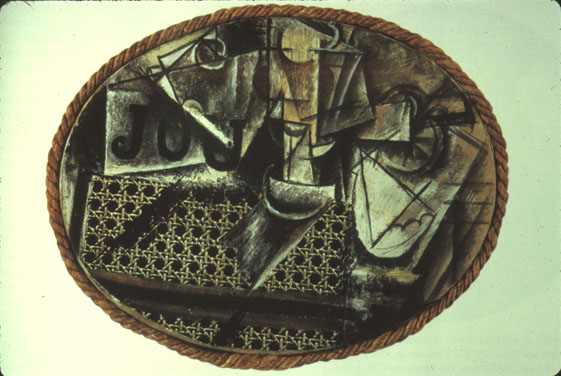 Pale green background behind a cubist painting of a table with items on it and a chair