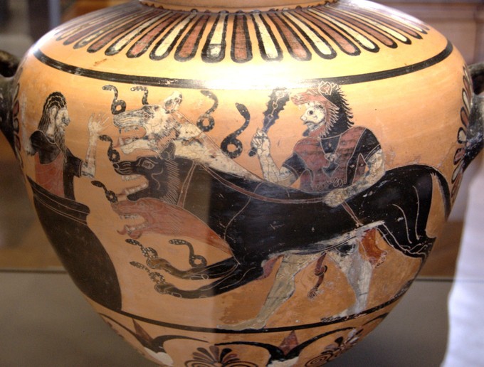 Round jar with a man carrying two lions towards another man