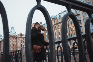 Two people hugging in a large city