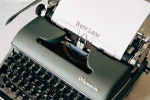 A paper that says "review" coming out of a typewriter